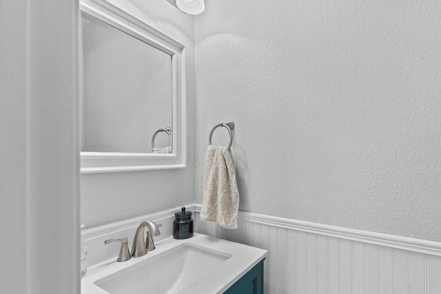 1401 Jackie Robinson Pl, Round Rock, TX 78665 - bathroom with vanity, wainscoting, and a textured wall