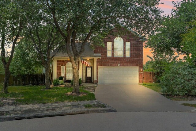 1401 Jackie Robinson Pl, Round Rock, TX 78665 - traditional home featuring concrete driveway, brick siding, and a garage