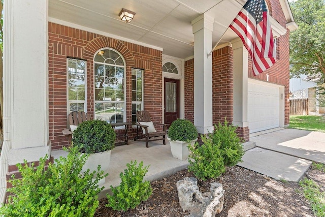 1401 Jackie Robinson Pl, Round Rock, TX 78665 - property entrance featuring covered porch, brick siding, concrete driveway, and an attached garage