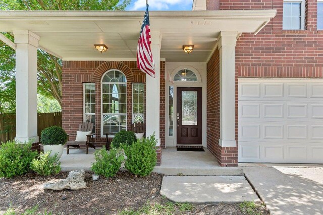 1401 Jackie Robinson Pl, Round Rock, TX 78665 - view of exterior entry with brick siding and a porch