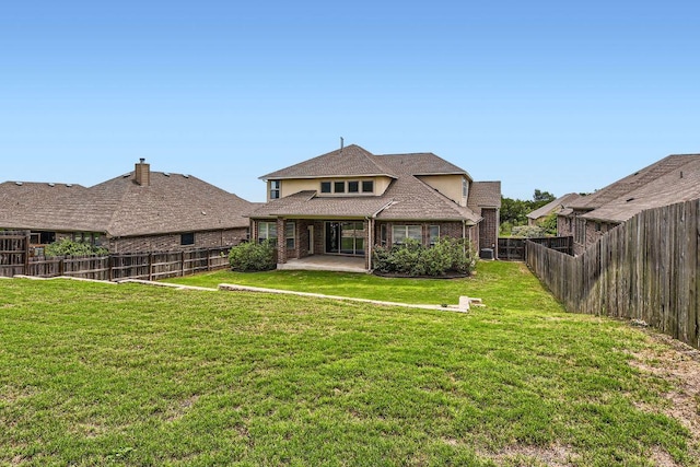 12383 Mesa Verde Dr, Austin, TX 78737 - rear view of house featuring a patio, a fenced backyard, and brick siding