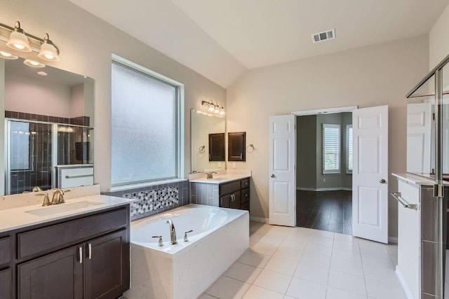 12383 Mesa Verde Dr, Austin, TX 78737 - bathroom with a stall shower, two vanities, a bath, tile patterned floors, and vaulted ceiling
