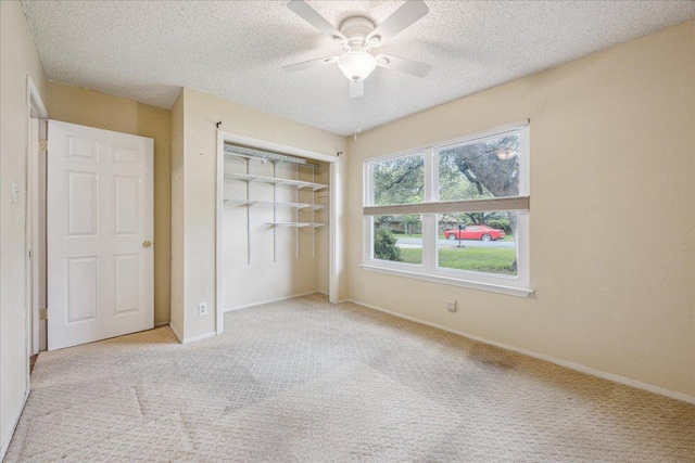 9613 Newberry Dr, Austin, TX 78729 - unfurnished bedroom featuring carpet floors, a closet, a ceiling fan, and a textured ceiling