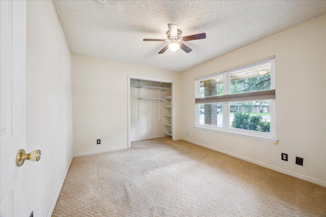 9613 Newberry Dr, Austin, TX 78729 - unfurnished bedroom featuring carpet, a textured ceiling, a closet, and ceiling fan
