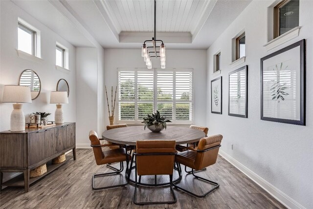 232 Cimarron Hills Trl E, Georgetown, TX 78628 - dining room with a tray ceiling, wood finished floors, a chandelier, and ornamental molding