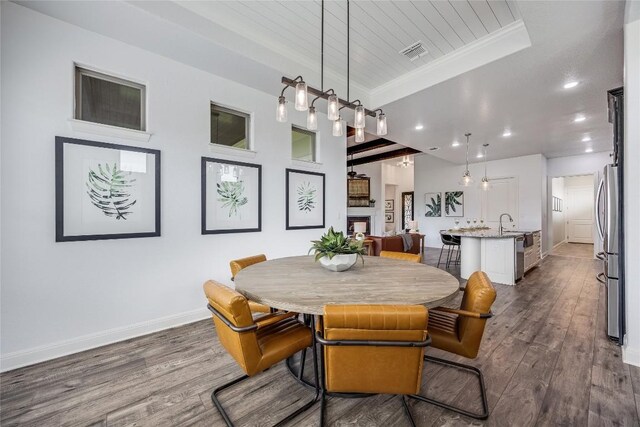 232 Cimarron Hills Trl E, Georgetown, TX 78628 - dining space with dark wood finished floors, recessed lighting, crown molding, wooden ceiling, and a raised ceiling