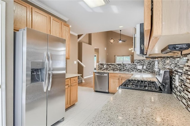 7500 Shadowridge Run Unit 47, Austin, TX 78749 - kitchen with stainless steel appliances, light brown cabinets, backsplash, vaulted ceiling, and light tile patterned floors