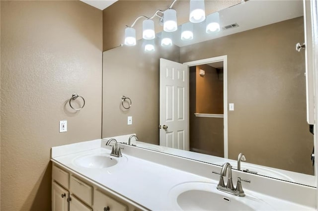 7500 Shadowridge Run Unit 47, Austin, TX 78749 - bathroom with double vanity and a textured wall