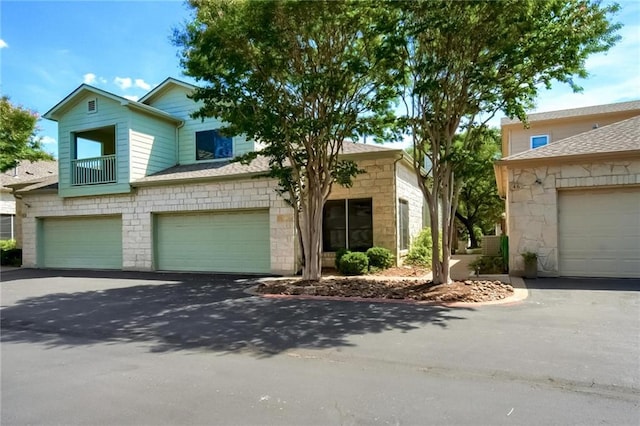7500 Shadowridge Run Unit 47, Austin, TX 78749 - view of front of property with stone siding, driveway, and an attached garage