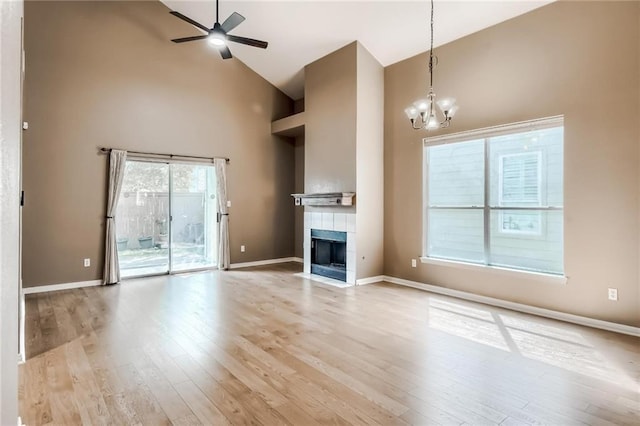 7500 Shadowridge Run Unit 47, Austin, TX 78749 - unfurnished living room featuring high vaulted ceiling, ceiling fan, wood finished floors, a chandelier, and a fireplace
