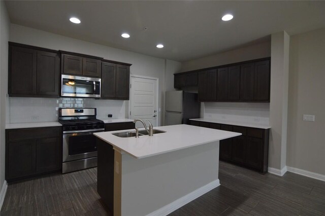 6814 E Riverside Dr Unit 52, Austin, TX 78741 - kitchen featuring stainless steel appliances, an island with sink, decorative backsplash, light countertops, and recessed lighting