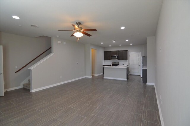 6814 E Riverside Dr Unit 52, Austin, TX 78741 - unfurnished living room featuring a ceiling fan, stairs, and recessed lighting