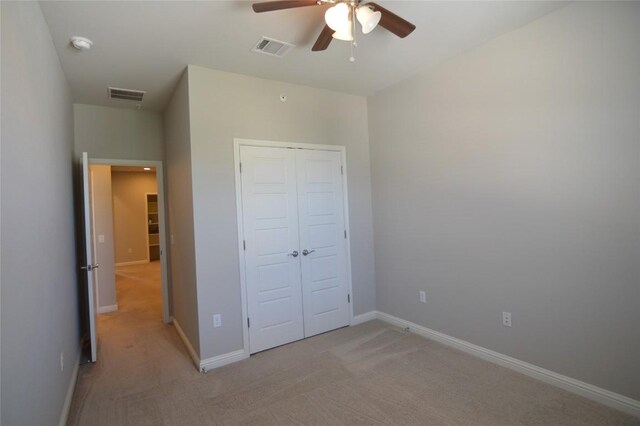 6814 E Riverside Dr Unit 52, Austin, TX 78741 - unfurnished bedroom with light colored carpet, a closet, and a ceiling fan