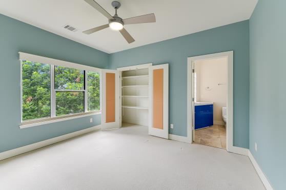 2822 Wooldridge Dr Unit B, Austin, TX 78703 - unfurnished bedroom featuring carpet, a closet, ensuite bathroom, and ceiling fan