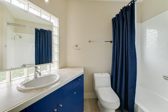 2822 Wooldridge Dr Unit B, Austin, TX 78703 - bathroom with vanity, shower / bath combo with shower curtain, and tile patterned floors