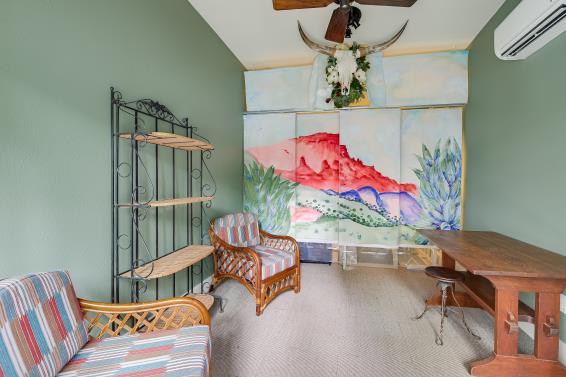 2822 Wooldridge Dr Unit B, Austin, TX 78703 - living area featuring a wall unit AC, ceiling fan, and lofted ceiling