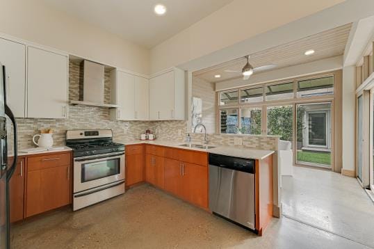2822 Wooldridge Dr Unit B, Austin, TX 78703 - kitchen with stainless steel appliances, wall chimney exhaust hood, light countertops, backsplash, and recessed lighting