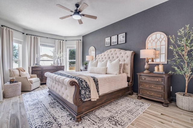 351 Kings Pine Dr, Dripping Springs, TX 78620 - bedroom featuring wood finished floors, multiple windows, and a ceiling fan