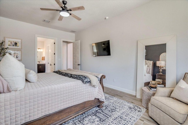 351 Kings Pine Dr, Dripping Springs, TX 78620 - bedroom with wood finish floors, connected bathroom, and a ceiling fan