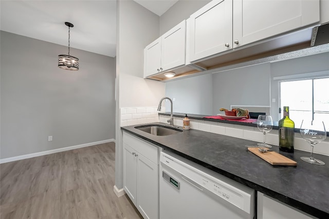 12166 Metric Blvd Unit 2011, Austin, TX 78758 - kitchen featuring dishwasher, dark countertops, white cabinetry, and light wood-style floors