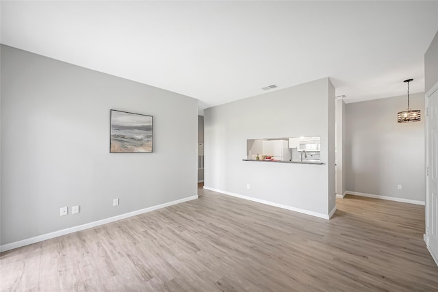 12166 Metric Blvd Unit 2011, Austin, TX 78758 - unfurnished living room with wood finished floors and a chandelier