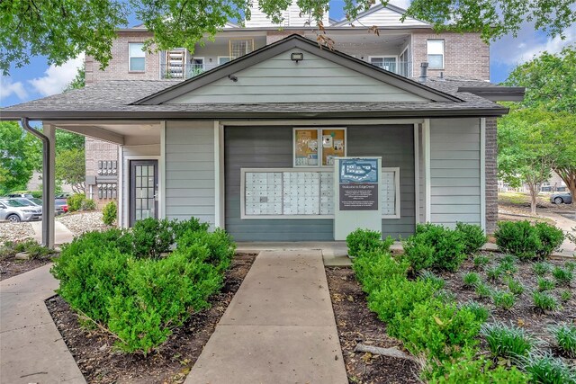 12166 Metric Blvd Unit 2011, Austin, TX 78758 - view of front of home with brick siding and roof with shingles