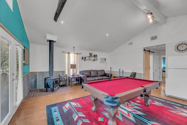 928 Moccasin Trl, La Grange, TX 78945 - rec room with a wood stove, wood finished floors, a barn door, and billiards table