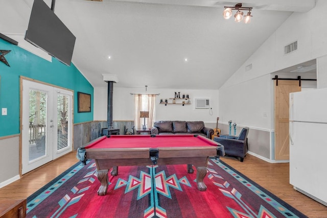 928 Moccasin Trl, La Grange, TX 78945 - rec room with wood finished floors, a wood stove, pool table, a barn door, and high vaulted ceiling