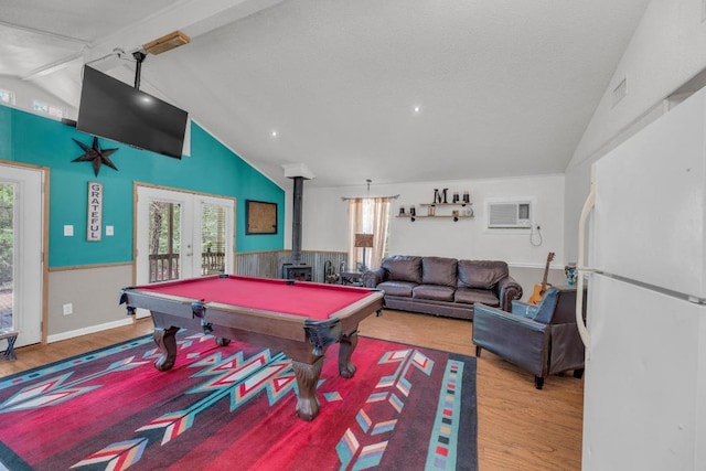 928 Moccasin Trl, La Grange, TX 78945 - game room with french doors, a wood stove, wood finished floors, a wall mounted air conditioner, and pool table