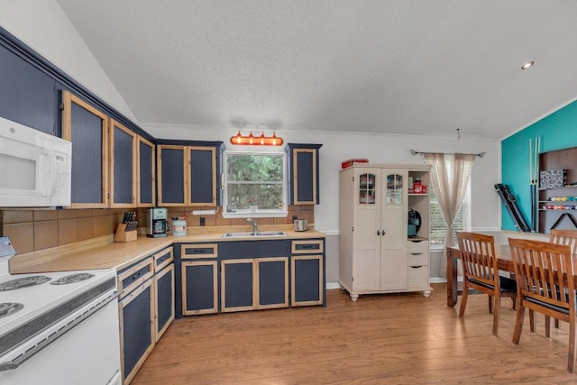 928 Moccasin Trl, La Grange, TX 78945 - kitchen with white appliances, a textured ceiling, light wood-type flooring, light countertops, and blue cabinets