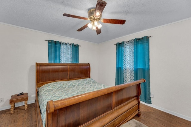 928 Moccasin Trl, La Grange, TX 78945 - bedroom featuring wood finished floors, a textured ceiling, and ceiling fan