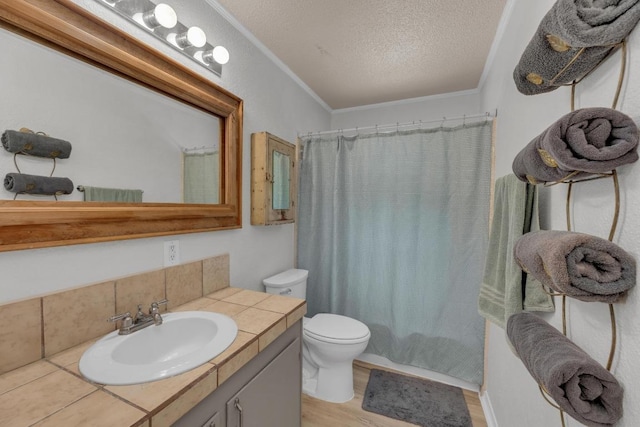 928 Moccasin Trl, La Grange, TX 78945 - full bath featuring vanity, wood finished floors, a textured ceiling, ornamental molding, and a shower with curtain