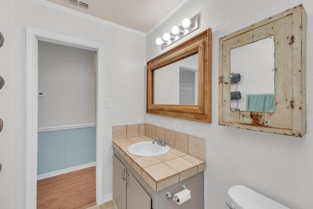 928 Moccasin Trl, La Grange, TX 78945 - half bathroom featuring crown molding, vanity, and wood finished floors