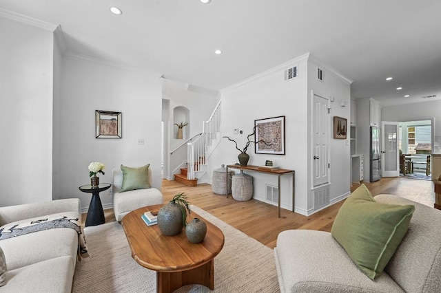 803 Jessie St, Austin, TX 78704 - living area with ornamental molding, recessed lighting, light wood finished floors, stairs, and arched walkways