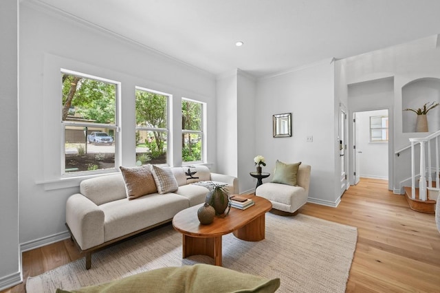 803 Jessie St, Austin, TX 78704 - living area featuring ornamental molding, light wood-style floors, and stairs
