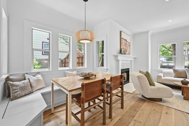 803 Jessie St, Austin, TX 78704 - dining area featuring crown molding, light wood-style flooring, a fireplace with flush hearth, and recessed lighting