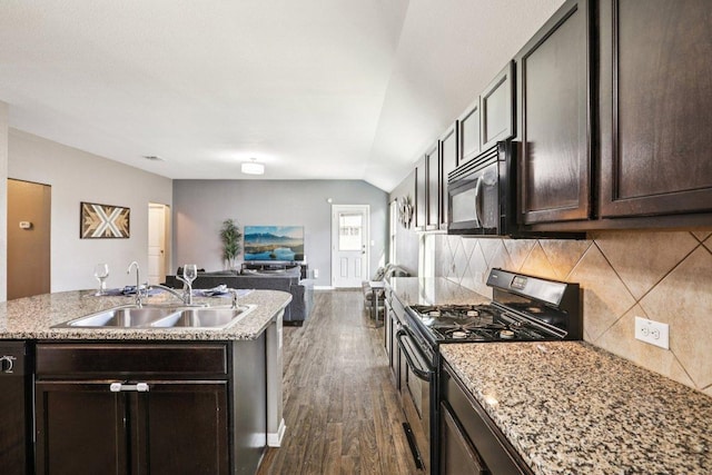 805 Red Tails Dr, Austin, TX 78725 - kitchen featuring black appliances, dark wood-style flooring, tasteful backsplash, dark brown cabinetry, and lofted ceiling