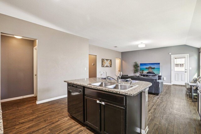 805 Red Tails Dr, Austin, TX 78725 - kitchen featuring black dishwasher, open floor plan, dark wood-style floors, a center island with sink, and vaulted ceiling