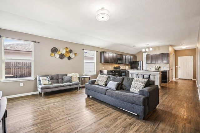805 Red Tails Dr, Austin, TX 78725 - living room featuring dark wood-style floors, lofted ceiling, and beverage cooler