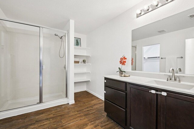 805 Red Tails Dr, Austin, TX 78725 - full bathroom featuring a shower stall, wood finished floors, and vanity