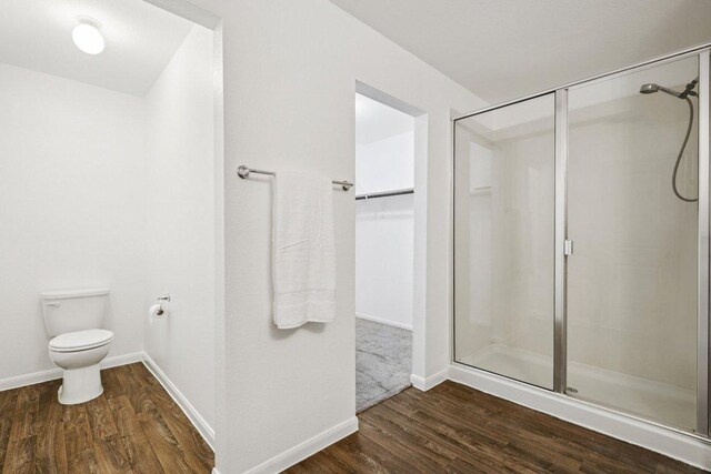 805 Red Tails Dr, Austin, TX 78725 - bathroom featuring a shower stall, wood finished floors, and a walk in closet