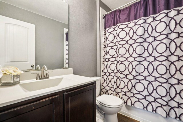805 Red Tails Dr, Austin, TX 78725 - bathroom with vanity, a textured wall, and wood finished floors