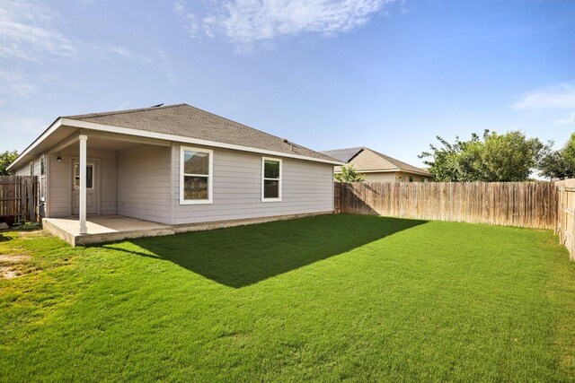 805 Red Tails Dr, Austin, TX 78725 - rear view of house with a patio area, a fenced backyard, and a shingled roof