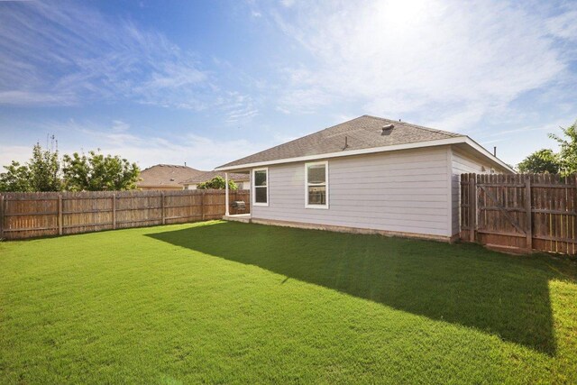 805 Red Tails Dr, Austin, TX 78725 - rear view of house with a fenced backyard