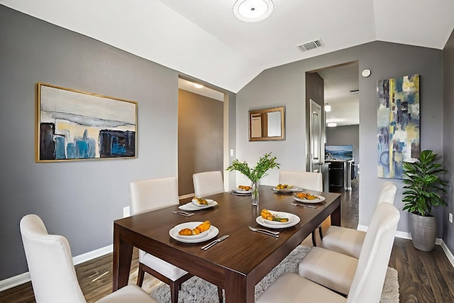 805 Red Tails Dr, Austin, TX 78725 - dining space featuring vaulted ceiling and wood finished floors