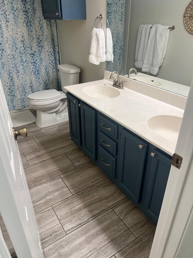8104 Ephraim Rd, Austin, TX 78717 - full bath with double vanity, wood finished floors, and a shower with curtain