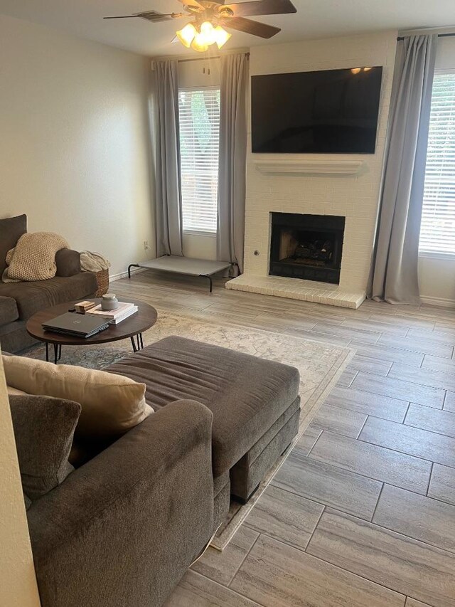 8104 Ephraim Rd, Austin, TX 78717 - living room with a ceiling fan, wood finished floors, and a fireplace