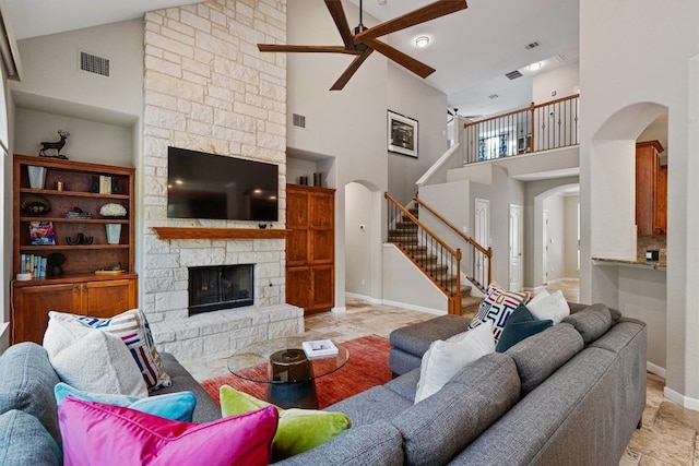6906 Covered Bridge Dr, Austin, TX 78736 - living area with arched walkways, high vaulted ceiling, ceiling fan, stairs, and a fireplace