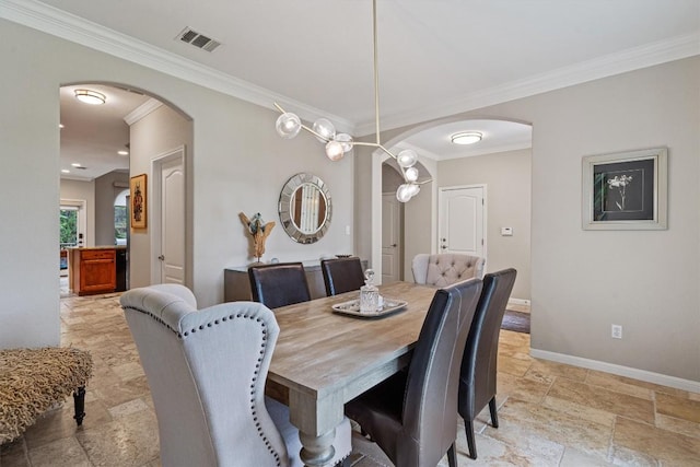 6906 Covered Bridge Dr, Austin, TX 78736 - dining space with arched walkways, stone tile flooring, and crown molding