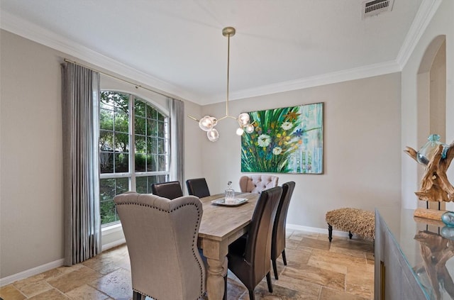6906 Covered Bridge Dr, Austin, TX 78736 - dining room with stone tile flooring, crown molding, and a chandelier